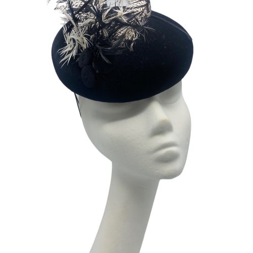 Stunning black velvet sloped beret shaped headpiece with monochrome feather detail. 